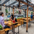 Chicago, IL - August 1, 2021: A young couple enjoys dinner on a patio, downtown in the Loop., License Type: media, Download Time: 2024-08-12T23:02:56.000Z, User: gemgraham87, Editorial: true, purchase_order: 65050, job: 65050, client: Chicago Neighborhoods, other: Gemma Graham